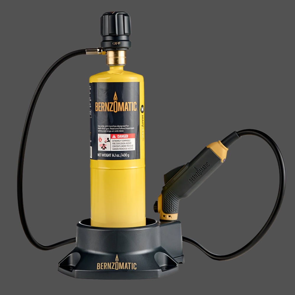 Yellow Bernzomatic torch with black hose on a gray background