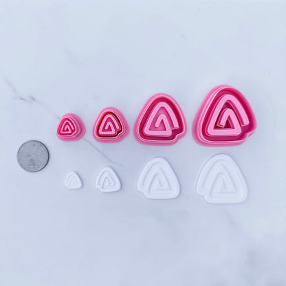 Triangular Swirls Cutters, coin used for scale